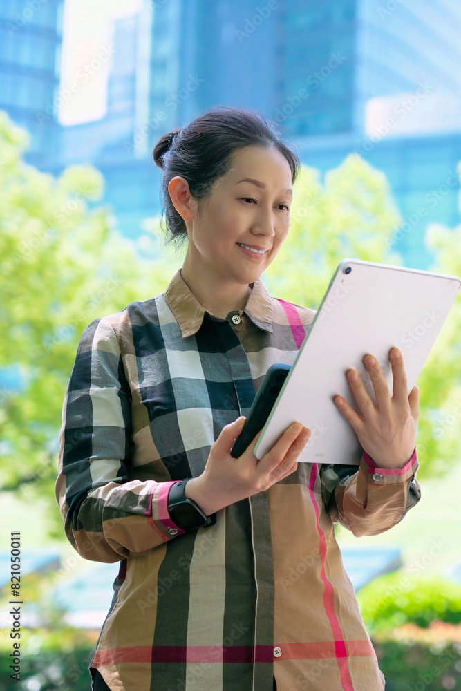 Professional Woman Engaged with Tablet in Urban Setting Professional Woman Engaged with Tablet in Urban Setting