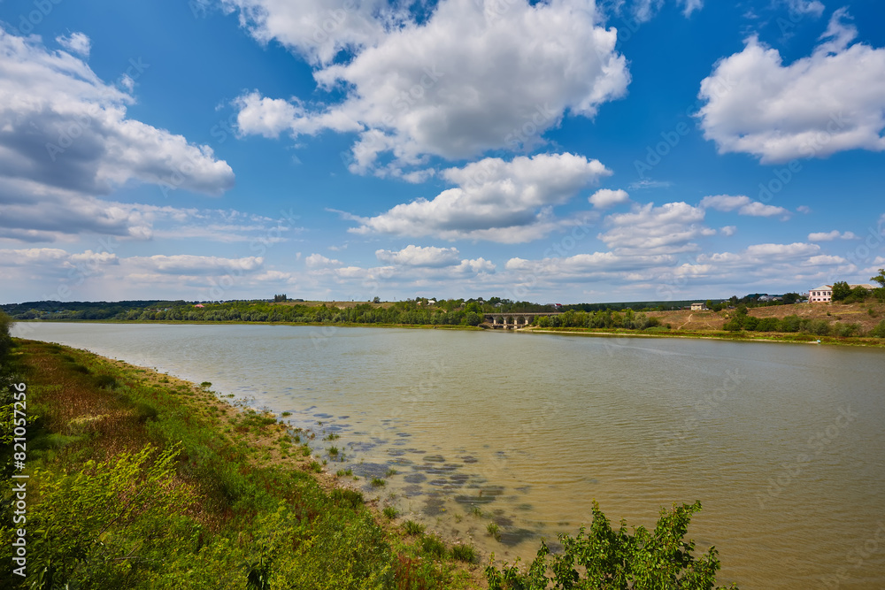 Beautiful landscape. Wide river, blue sky with white clouds. Beautiful landscape. Wide river, blue sky with white clouds.