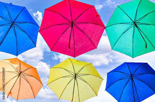 Background of many hanging colorful umbrellas decorating the street of a town	