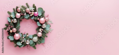 a christmas wreath on pink background, christmas concept, copy space, flat lay, top view
