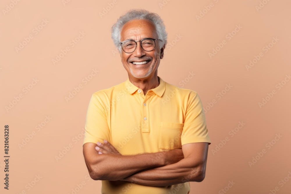 Portrait of a joyful afro-american man in his 80s with arms crossed isolated on minimalist or empty room background Portrait of a joyful afro-american man in his 80s with arms crossed isolated on minimalist or empty room background