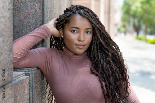 Pretty african american female young adult with braids photo