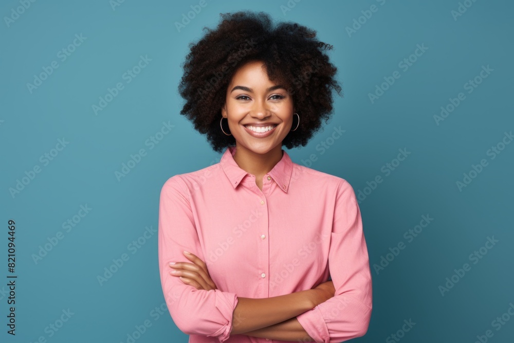 Portrait of a satisfied afro-american woman in her 20s with arms crossed over solid color backdrop Portrait of a satisfied afro-american woman in her 20s with arms crossed over solid color backdrop