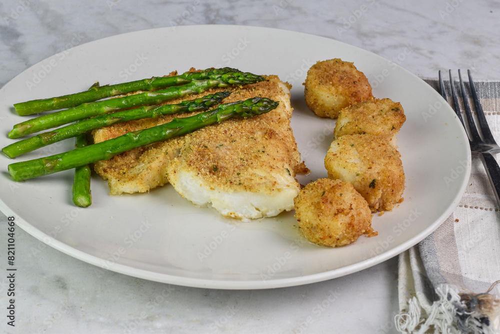 baked haddock served with asparagus and scallops