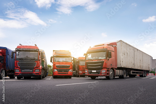 Fleet of Commercial Trucks Parked on Highway photo