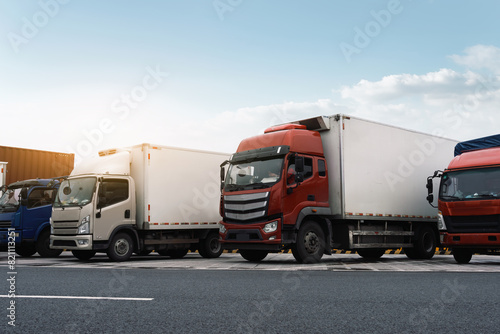 Commercial Fleet of Trucks Parked on Roadside © 昊 周