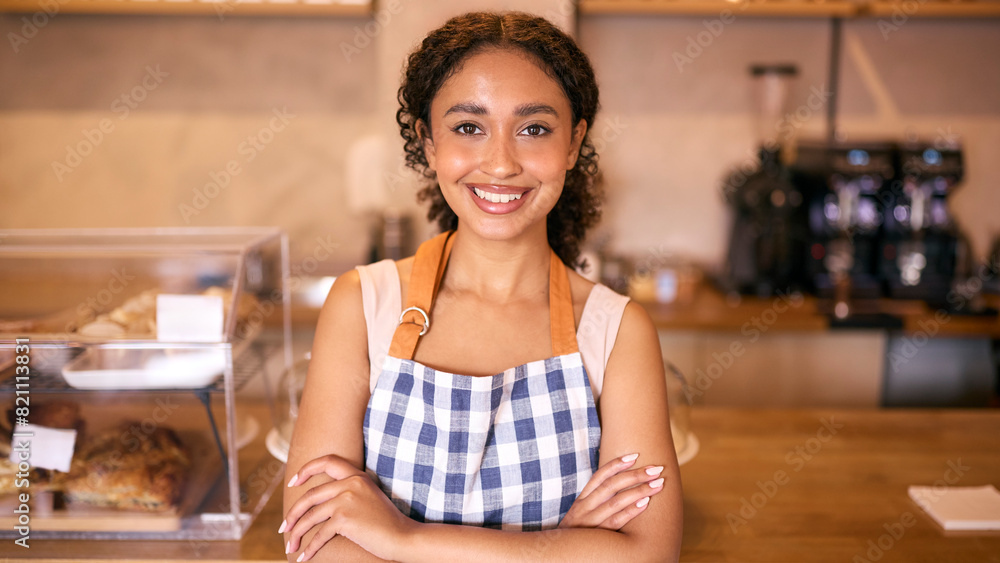 Portrait Of Confident Young Woman Wearing Apron Working In Coffee Shop Or Cafe Portrait Of Confident Young Woman Wearing Apron Working In Coffee Shop Or Cafe