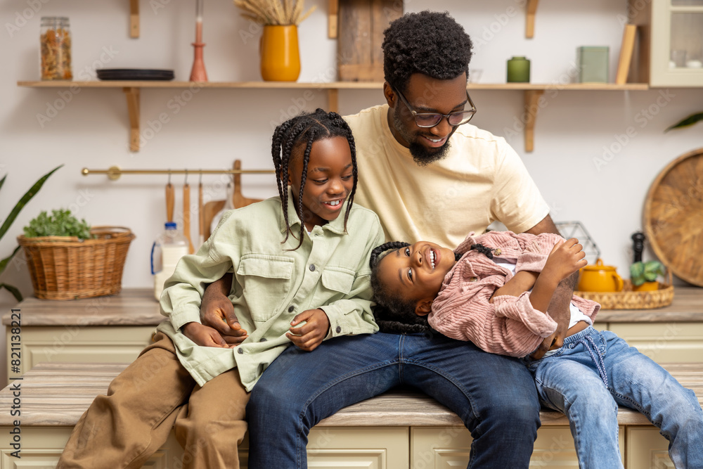 African American man enjoying leisure time with his daughters African American man enjoying leisure time with his daughters