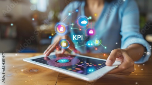 graphs hovering over a tablet with the word "KPI" businesswoman holding tablet show virtual graphic 