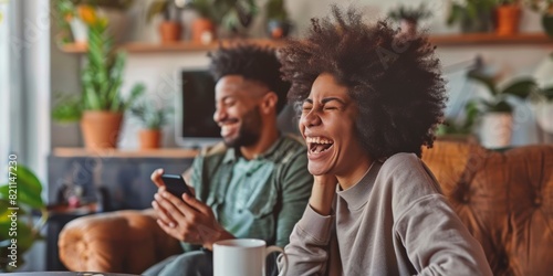 Video call with woman laughing for joke, meme, or home conversation. Female talking on phone with laugh for amusing or entertaining conversation at living room table. photo