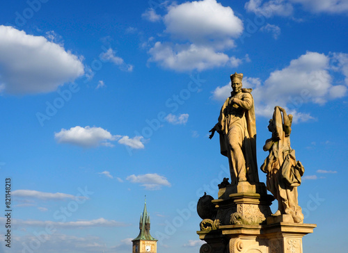 Isolated view of the 18th century monument of St Francis Borgia with two angels. Charles Bridge. Moody, overcast cloudy sky background.