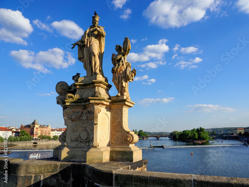 Isolated view of the 18th century monument of St Francis Borgia with two angels. Charles Bridge. Moody, overcast cloudy sky background. © Игорь Головнёв