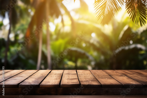 Empty wooden planks or tabletop in front of a blurred bokeh lush tropical forest and maximalist background a product display background or wallpaper concept with backlighting photo