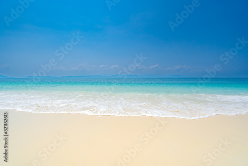 Clean white sandy beach welcoming blue waters on a clear day  Phuket Island  Thailand  Asia