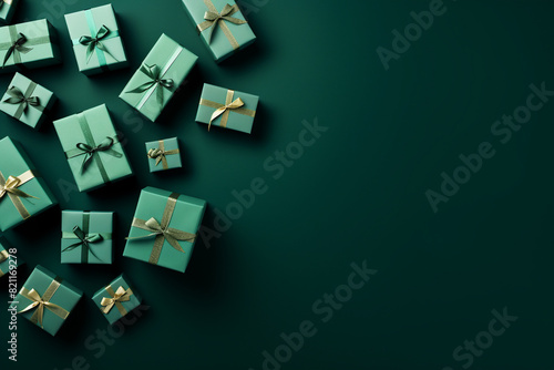 romantic green background with a small pile of wrapped gift boxes at one side seen from above for a birthday © pangamedia