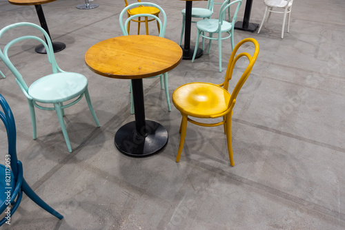 Colorful wooden chairs and tables in a public restaurant. Public places for eating quick meals.