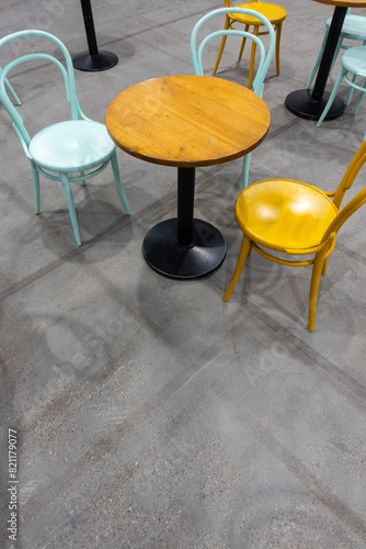 Colorful wooden chairs and tables in a public restaurant. Public places for eating quick meals.