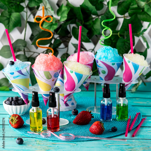 Colourful snow cones with fruit flavoured syrups, ready for sharing.