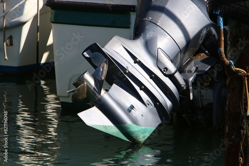 The propeller of a motor boat at the pier in the seaport.