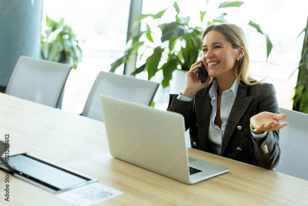Bright morning business call in modern office setting with greenery Bright morning business call in modern office setting with greenery