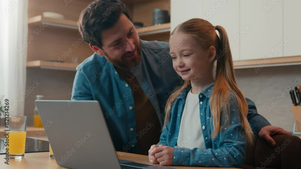 Little daughter clever child kid girl schoolgirl pupil development e-learning home distant education smile in kitchen adult father loving care dad help with laptop using teach browsing computer app Little daughter clever child kid girl schoolgirl pupil development e-learning home distant education smile in kitchen adult father loving care dad help with laptop using teach browsing computer app