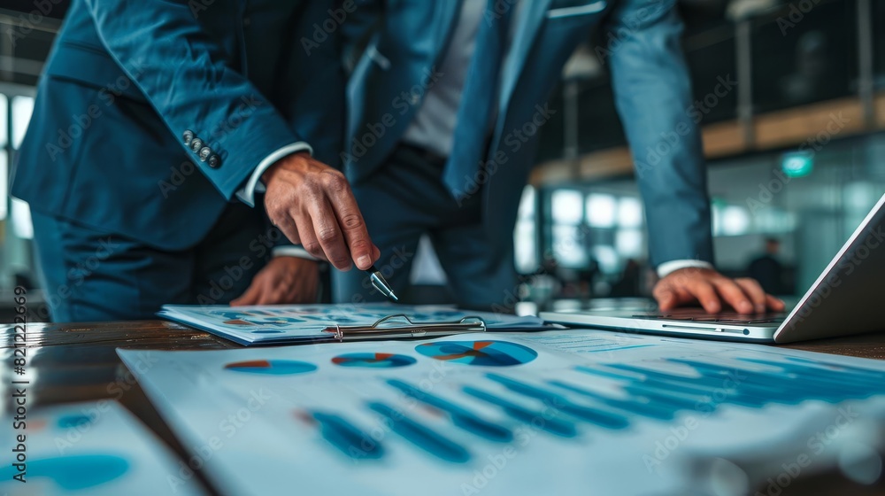 Fototapeta premium Business partners analyzing sales data on a holographic display table