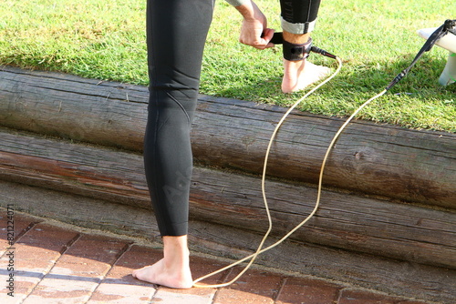 An athlete walks barefoot on the sand on the seashore.