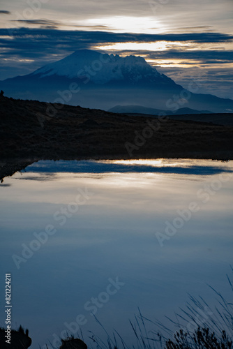 Antisana volcano in a cold misty mountain as seen from Taracocha lake, in the ecuadorian Andes