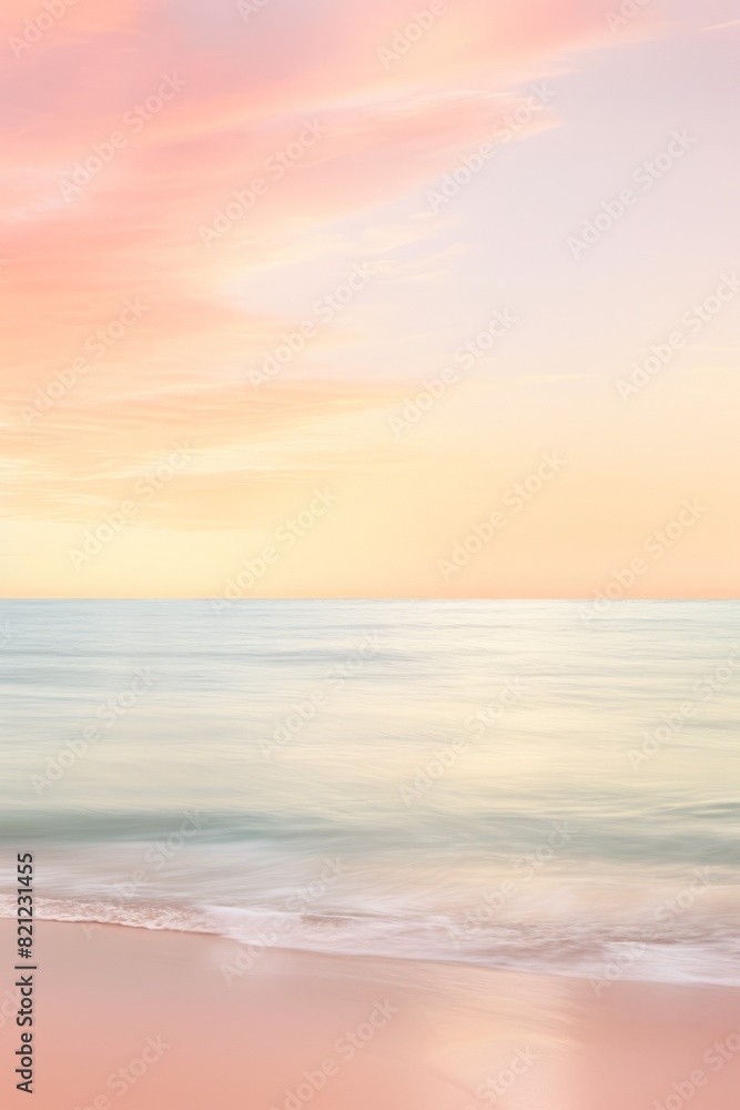 Fototapeta premium Pastel sunrise over calm ocean. The photo depicts a serene scene with soft pink and yellow hues in the sky reflecting. Vertical image with copy space.. soft foto