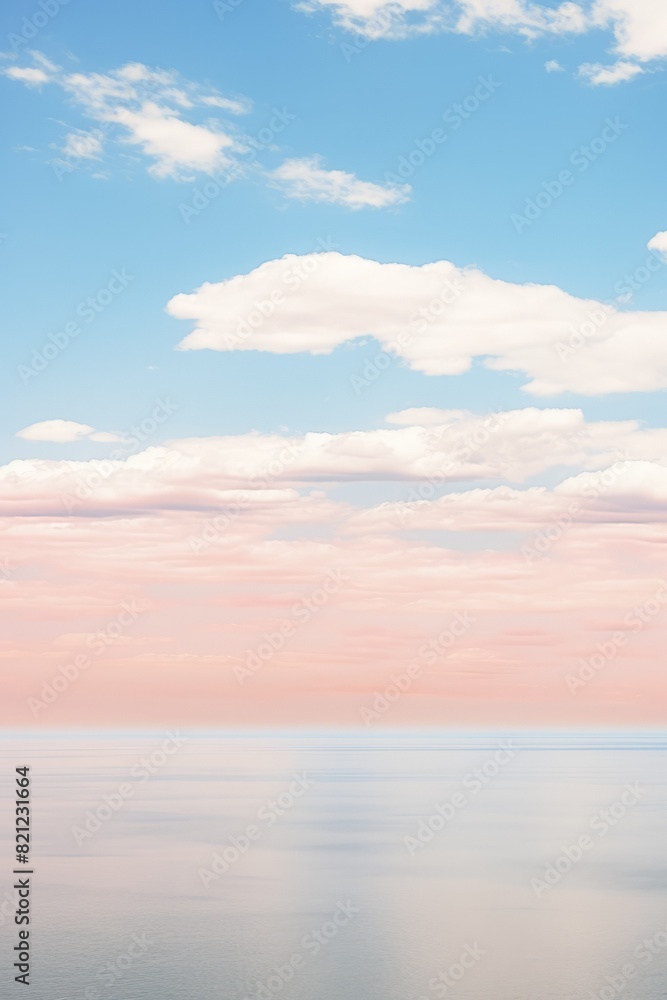 beach with calm sea and blue sky. The photo shows a tranquil seascape with gentle waves lapping the shore and fluffy white clouds scattered across the sky. Vertical image with copy space. soft focus beach with calm sea and blue sky. The photo shows a tranquil seascape with gentle waves lapping the shore and fluffy white clouds scattered across the sky. Vertical image with copy space. soft focus
