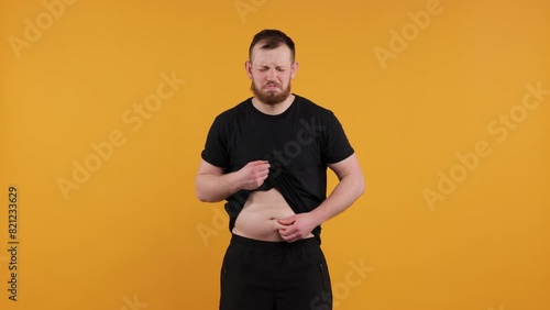 Overweight Male Stomach

Young man with a naked, overweight belly shaking fat folds on his stomach. Represents obesity, health issues, and beer belly. Ideal for health-related projects and discussions