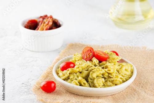 Italian pasta Creste Di Gallo with fresh cherry tomatoes and pesto sauce.