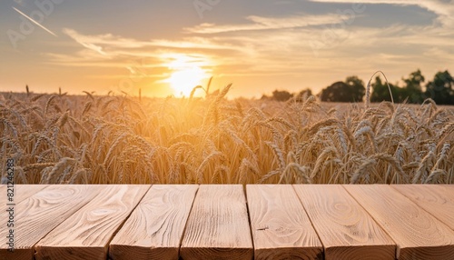 wooden board table in front of wheat field on sunset light ready for product display montages photo