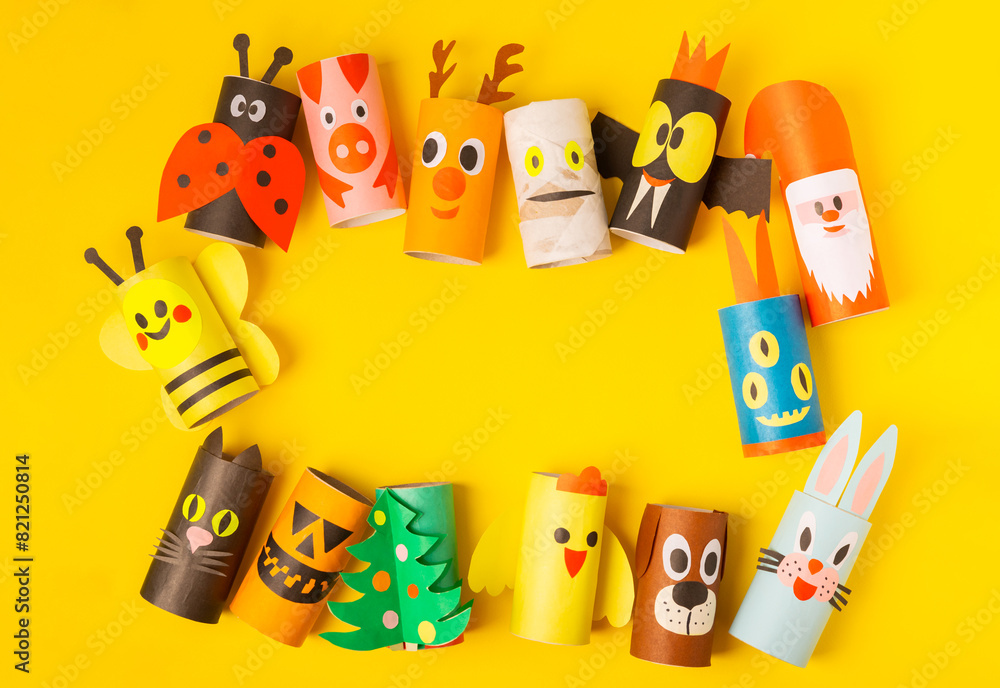 Obraz premium Toilet paper crafts on a colored background. Kids crafts made with toilet paper roll. DIY. Handmade. Paper toys. Origami animals. Concept of children's educational games. Place for text. Copy space.