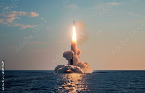 A submarine missile is dramatically launching from the ocean surface at sunset, with fiery trail photo