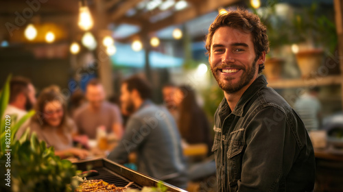Fototapeta Naklejka Na Ścianę i Meble -  Portrait of man barbecuing, family and friends having fun at nice barbecue in the summer. Grilling sausages, meat, vegetables outside in the backyard at garden party.