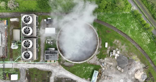 Aerial drone view of a smoking smokestack at a chemical park in Rheinberg, North Rhine Westphalia, Germany. photo