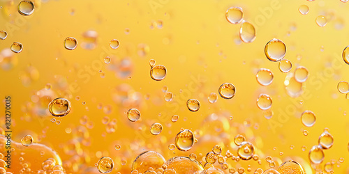 close-up of oil bubbles floating in an orange liquid water bubbles on yellow surface