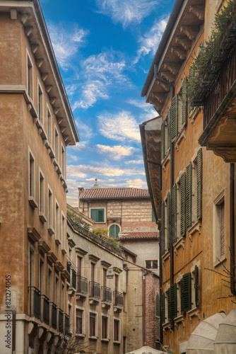 A view from inside on of the streets of Verona - Italy looking up at the sky with the facades of the buildings  © Felix Tchvertkin