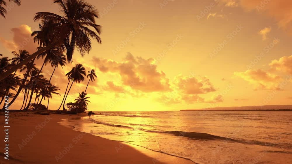 Calm waves crash onto a sandy beach against the backdrop of a sea California sunset. Serene summer seascape. Reflection of the sun in wet sand. Glowing clouds over the ocean. Calm waves crash onto a sandy beach against the backdrop of a sea California sunset. Serene summer seascape. Reflection of the sun in wet sand. Glowing clouds over the ocean.