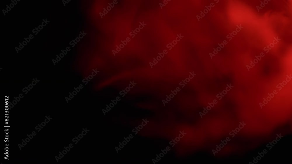 Explosion of Red Smoke or Powder on Black Blurred Background. Abstract, side view. Red soft puffs of smoke or steam mix chaotically on empty space. Particle explosion, bright light. Slow motion. Explosion of Red Smoke or Powder on Black Blurred Background. Abstract, side view. Red soft puffs of smoke or steam mix chaotically on empty space. Particle explosion, bright light. Slow motion.