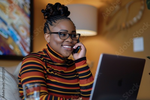 Woman Sitting at Desk Talking on Cell Phone