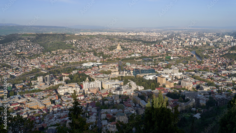 Wide angle view of beautiful city if Tbilisi and Kura river from Mount Mtatsminda with Holy Trinity Cathedral in the center and Old Town on the right side