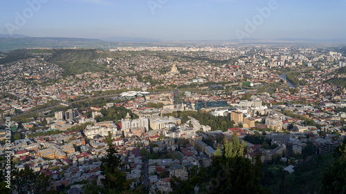 Wide angle view of beautiful city if Tbilisi and Kura river from Mount Mtatsminda with Holy Trinity Cathedral in the center and Old Town on the right side © berezko