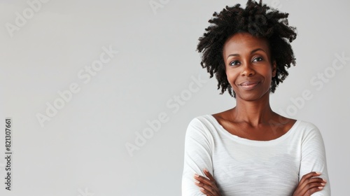 A confident woman standing with arms crossed photo