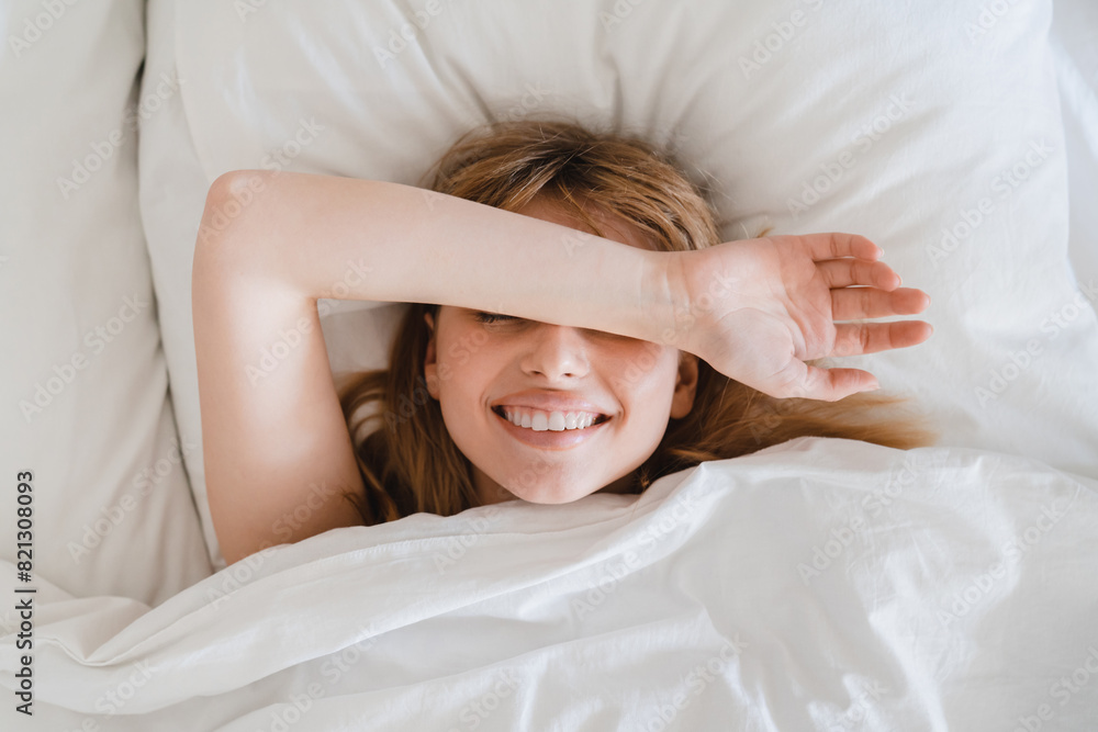 Sleeping serene young woman lying on white linen on comfy bed in the morning, starting the new day, bedding on orthopedic mattress on weekends Sleeping serene young woman lying on white linen on comfy bed in the morning, starting the new day, bedding on orthopedic mattress on weekends