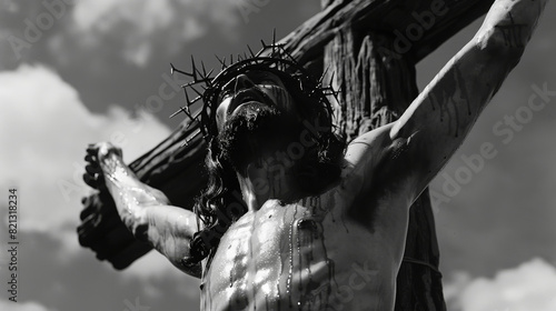 Jesus wearing a crown of thorns, crucified on a cross against the sky.