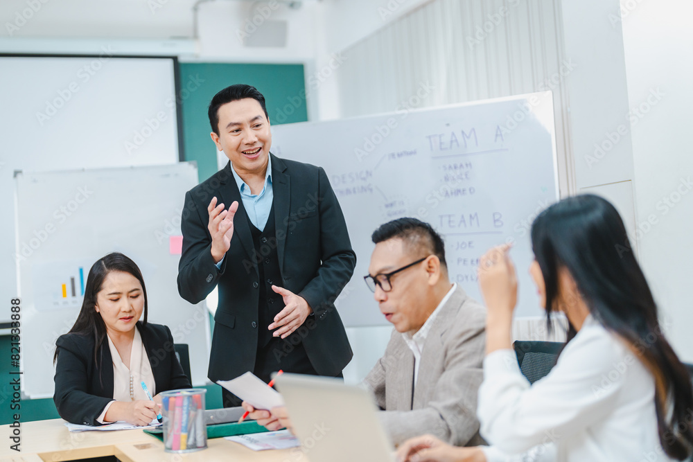 © chokniti - Asian businessman present start up project to expert investor, Teamwork group of multicultural business team solving problems, discussing business idea with skyscraper at modern business lounge