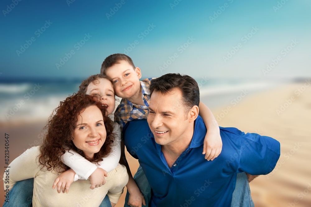 Happy family fun together on a sandy beach Happy family fun together on a sandy beach