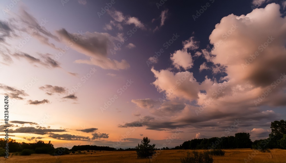 Serene rural field under a tranquil sunset sky with dramatic clouds Serene rural field under a tranquil sunset sky with dramatic clouds
